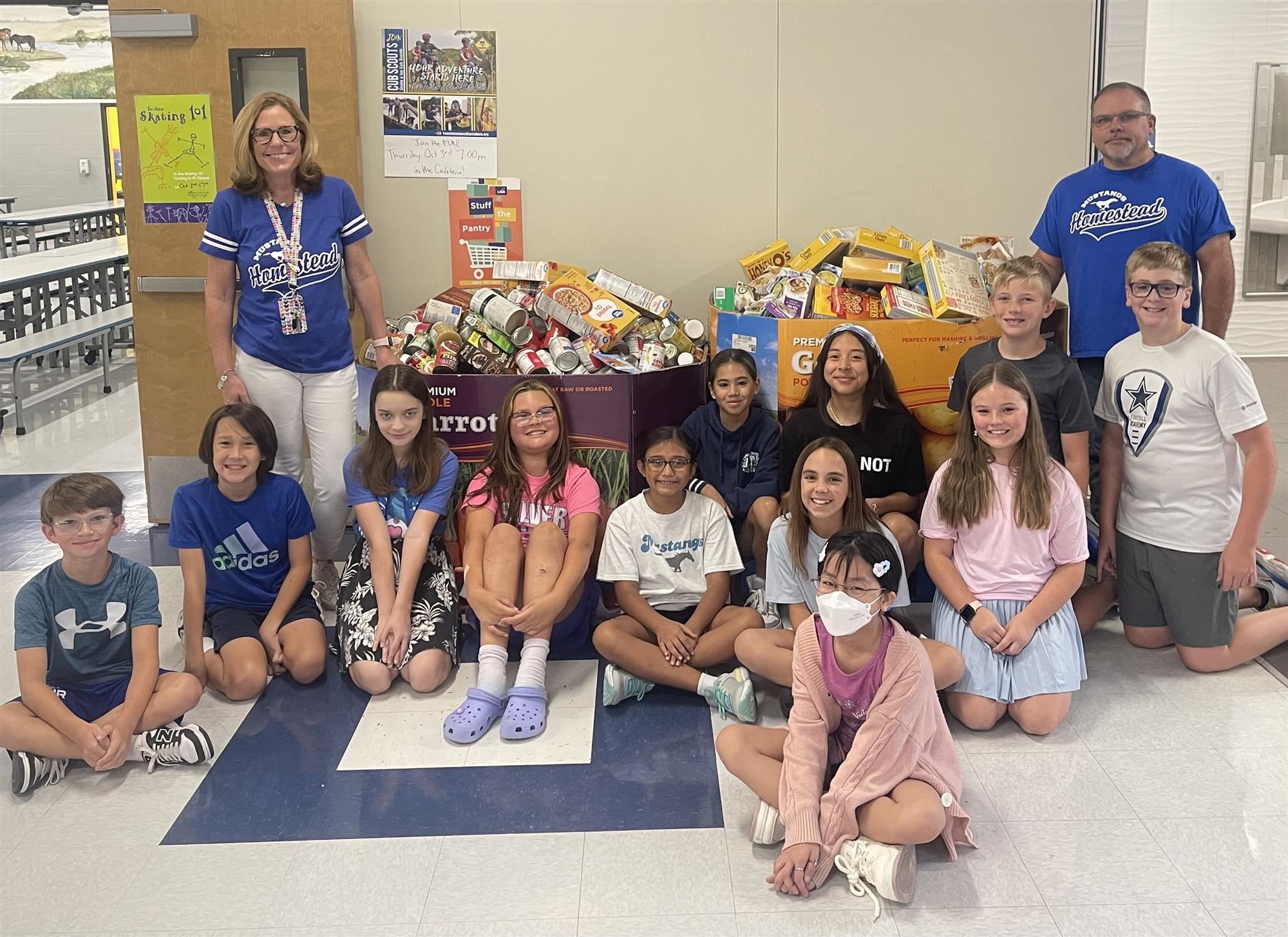 Homestead Elementary students and staff pose with donations to this years food drive benefitting CCA. October 2024